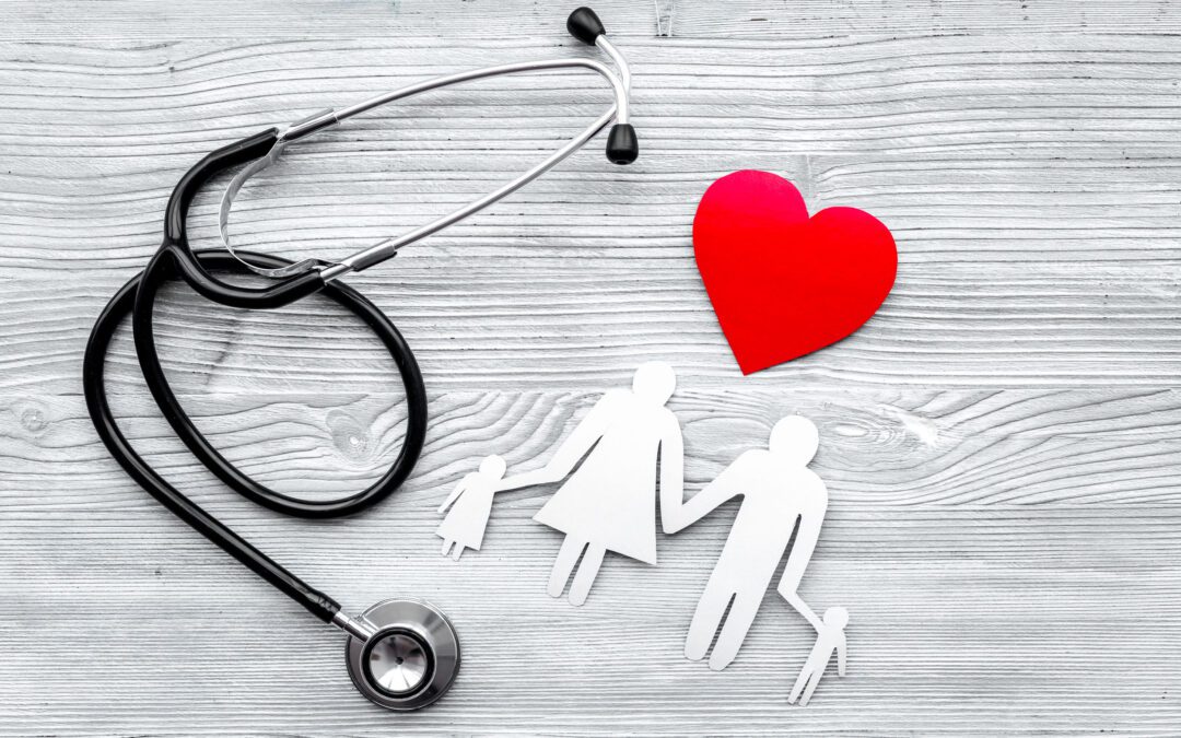 A stethoscope, a red heart, and a paper cutout of a family.