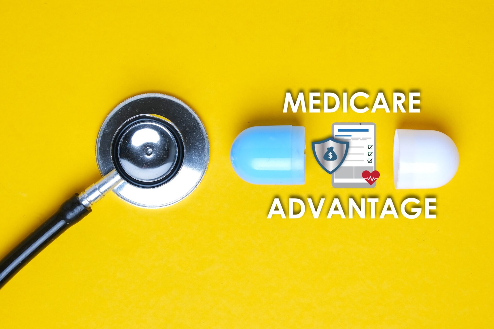 A picture of a stethoscope with a fake capsule, medicare advantage word, tablet, money shield, and heart.