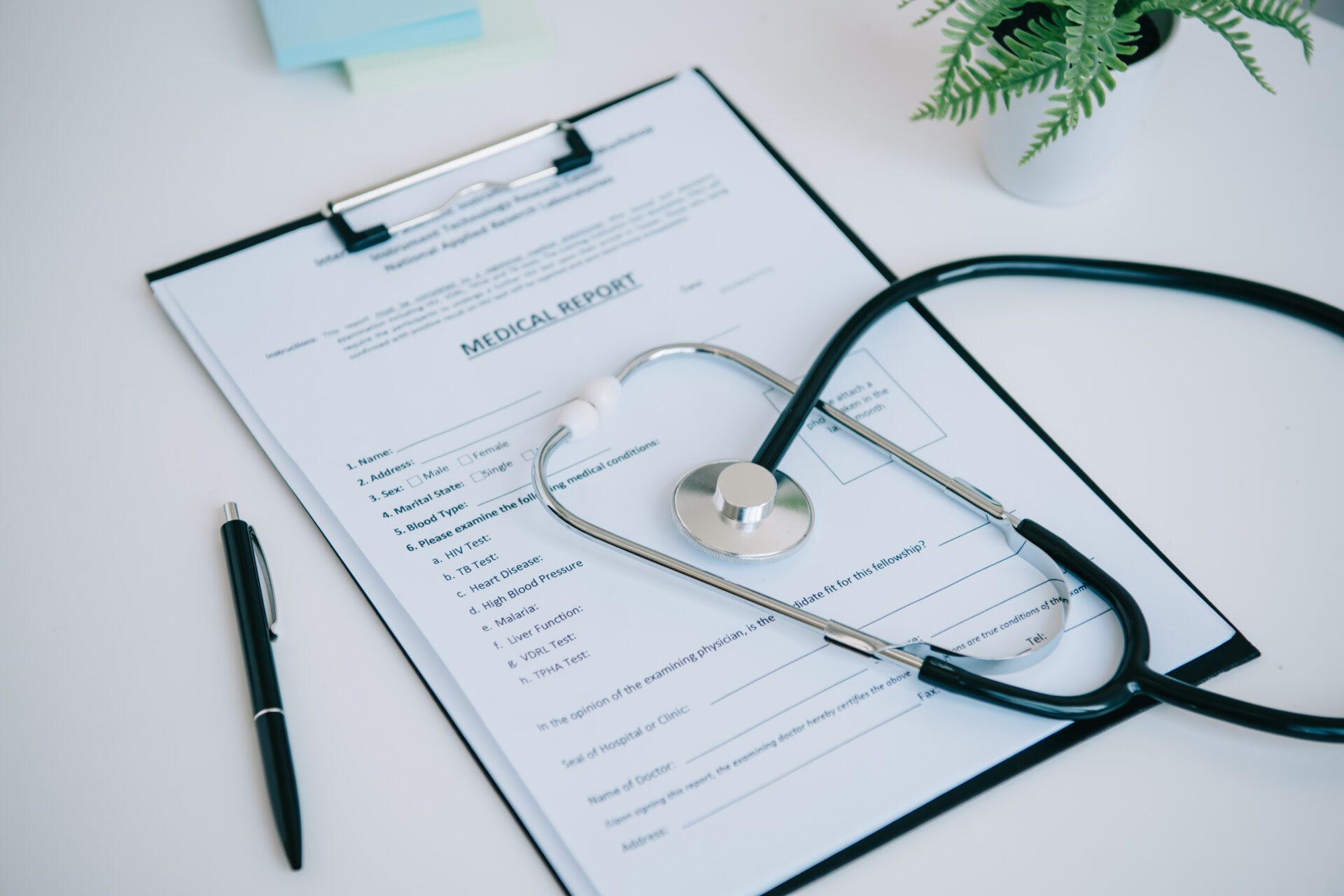 A medical report with a stethoscope placed on the table.