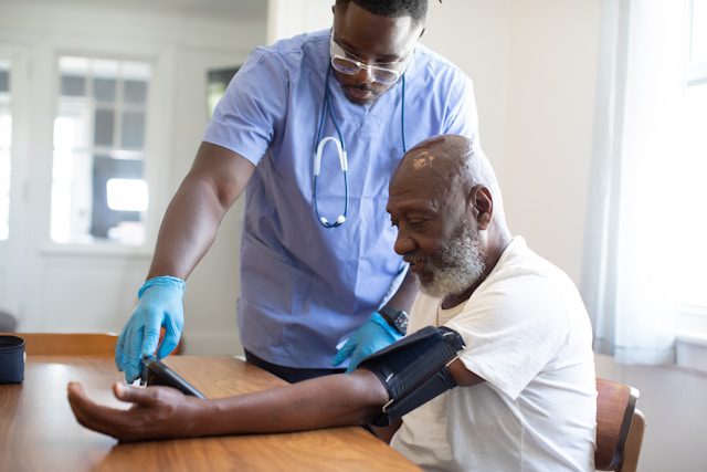 A doctor checking the vitals of the patients to assess their health condition.